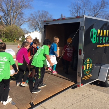 Students loading food drive items